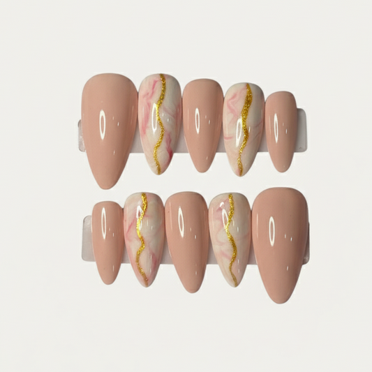 Set of pink nail caps with gold and white marbling on a light gray background