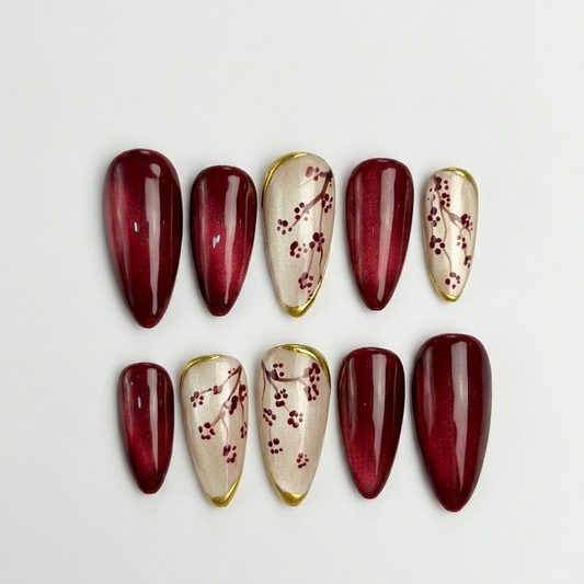 Set of maroon and beige nail designs on a white background
