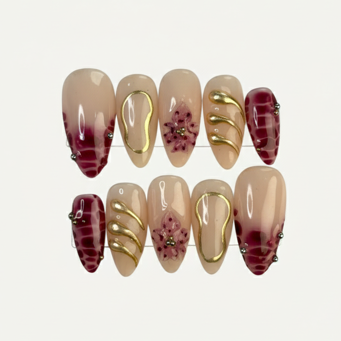 Set of press-on nails with gradient and pattern designs on a light background