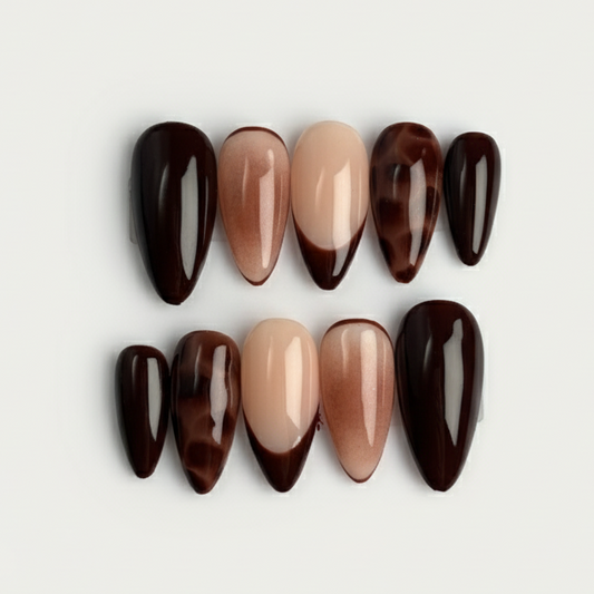 Set of brown and beige nail polish bottles on a light gray background
